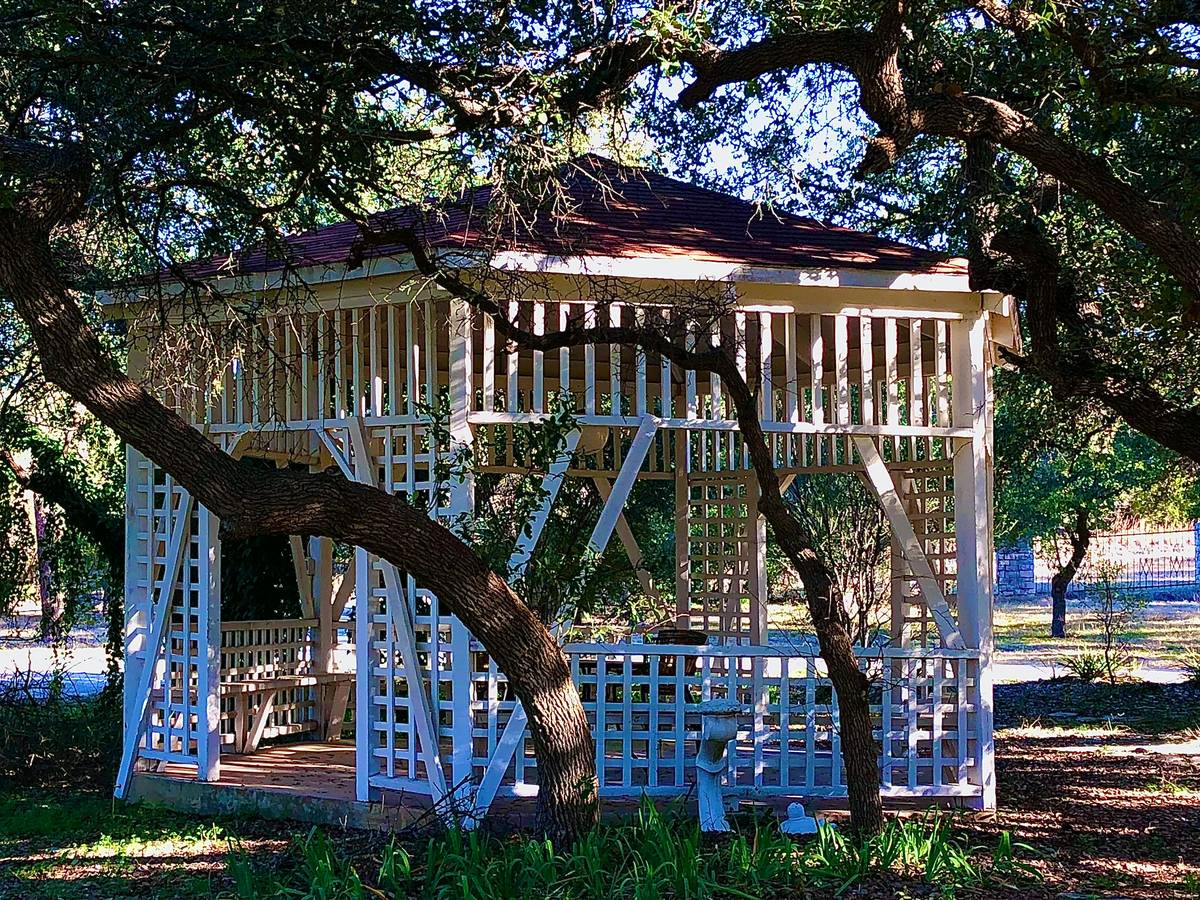 Stylish backyard gazebo furniture setup with modular seating and matching table