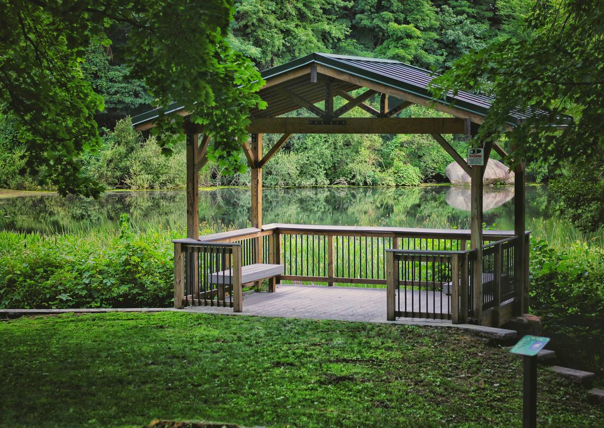 Close-up of sturdy patio gazebo furniture table anchored securely to wooden deck with visible fasteners