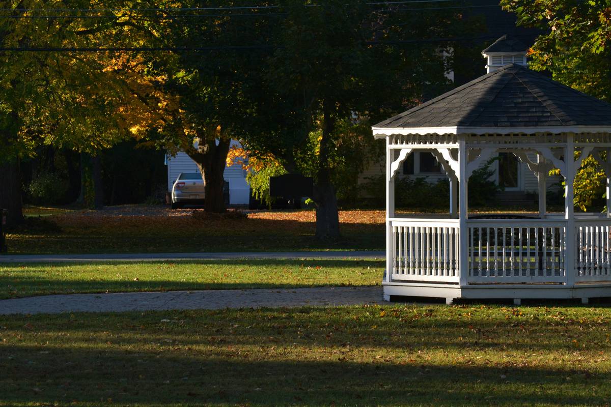 Properly installed outdoor furniture gazebo metal set with rubber feet and drainage gaps beneath seat cushions